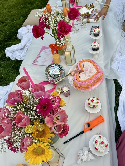 midsummer, backyard party, flowers, backyard lights, candles, birthday party, aesthetic, summer, summer bucket list, pink, orange, pink and orange, disco balls, cupcakes, cake, heart shaped cake, aesthetic cake, table layout