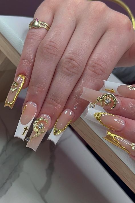 Nails fit for a queen! These striking long cutout-shaped nude nails are adorned with opulent gold charms, creating a luxurious and elegant look. The intricate white French and gold embellishments, along with delicate jewels, elevate this chic design to a whole new level of sophistication. Get ready to turn heads and leave a lasting impression with this stunning manicure! // Photo Credit: Instagram @the.vanilla.nails Instagram, Acrylics, Acrylic Nail Designs, Gold Acrylic Nails, Acrylic Nails Coffin Pink, Nails With Gold, Simple Acrylic Nails, Gold Nails French, White Acrylic Nails