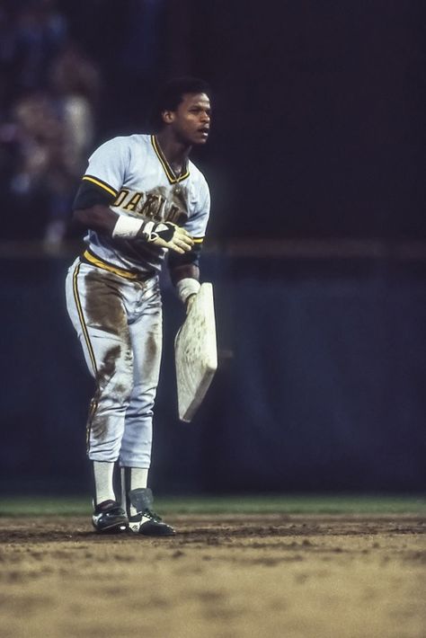Rickey Henderson takes his 119th stolen base, breaking Lou Brock's season record.  Rickey Henderson maintains the MLB record for stolen bases, at 1406. He also leads the league in runs at 2295. Known for his eccentric personality and passion for baseball, his #24 jersey is retired by the A's, he was inducted into the Hall of Fame in 2009. Summer, Baseball, American Football, Man, American League, Mlb Baseball, Baseball Photography, Sports Hero, Sports Pictures