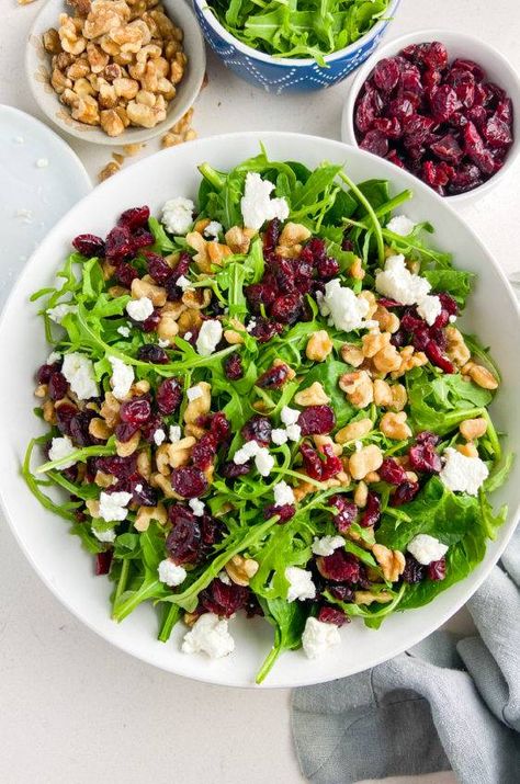 This salad is the perfect festive side dish! Loaded with arugula, spinach, goat cheese, walnuts and cranberries, it'll be right at home on your holiday table. Visit. www.lifesambrosia.com for the full recipe!