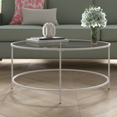 Is the seating ensemble feeling empty? Try a coffee table! Not only do they anchor your space, but they offer room to stage a display and serve up trays of treats when you find yourself entertaining. This one, for example, has a simple round shape, tempered glass top, and four straight legs, creating clean lines that can blend smoothly with the modern and contemporary aesthetic. We recommend wiping with a dry clean cloth to keep clean. This piece requires assembly upon arrival. Colour: White Home Décor, Interior, Sofas, Design, Round Coffee Table Modern, Counter Stools, Round Coffee Table, Modern Coffee Tables, Bar Stools
