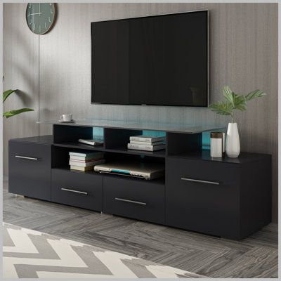 Modern LED TV Stand: Stylish and modern television stand features built-in LED lighting with 16 static colors and 4 lighting modes. Color: Black | Latitude Run® TV Stand for TVs up to 70" Wood in Black, Size 19.0 H in | Wayfair Home Décor, Home, Tv Stand With Led Lights, Tv Stands And Entertainment Centers, High Tv Stand, Tv Stand Living Room, Tv Stand, Black Tv Stand, Tv Cabinet Design