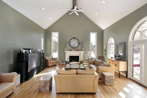 A simple formal living room with beige sofa set on top of the hardwood flooring. The fireplace looks perfect together with the white vaulted ceiling. Interior, Home Décor, Vaulted Ceiling Paint Ideas, Vaulted Ceiling Ideas, Vaulted Ceiling Living Room, Vaulted Living Rooms, Types Of Ceilings, Vaulted Ceiling, Room Decor