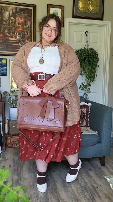 Plus sized brunette girl wearing white frilly top, long red orange floral print skirt, cozy tan cardigan, white maryjane shoes and a brown leather bag. Background has a variety of paintings, prints, and plants. Fashion, Clothes, People, Reference, Girl Outfits, Style, Cute Outfits, Outfit, Moda