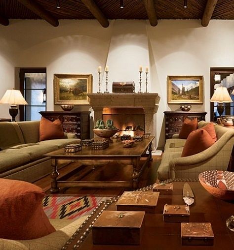 "It's a nice house, but it's not fancy," says Turner, who hired San Antonio architect Chris Carson and Dallas interior designer Laura Hunt to carry out the design.  For the great room, as throughout, Hunt wanted "European overtones," she says. Paintings by Albert Bierstadt flank the fireplace, and a side table displays circa 1910-40 Navajo copper boxes. Vigas, typical of Spanish colonial architecture, were stained dark brown. John Rosselli lamps. Southwest Interiors, Southwest Interior Design, Southwest Interior, Spanish Style Homes, Spanish Style Home, Hacienda Style Homes, Dallas Interior Design, Spanish House, Hacienda Style