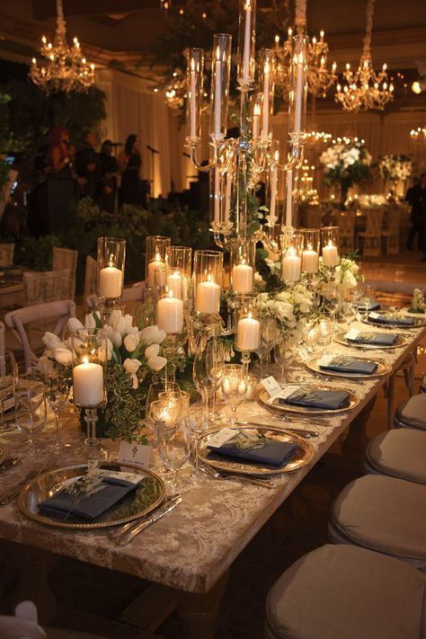 Candelabra and pillar candles on crystal stands filled the table along with tulips. Wedding Decor, Luxury Wedding Centerpieces, Glamorous Wedding Decorations, Candlelight Wedding Reception, Wedding Reception Tables Centerpieces, Wedding Tablescapes, White Candles Wedding, Wedding Reception Centerpieces, Wedding Table Decorations