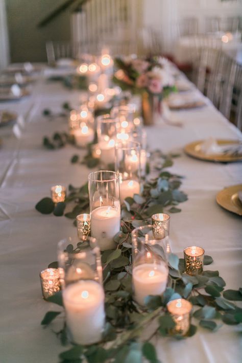 romantic greenery garland wedding table setting with candle light