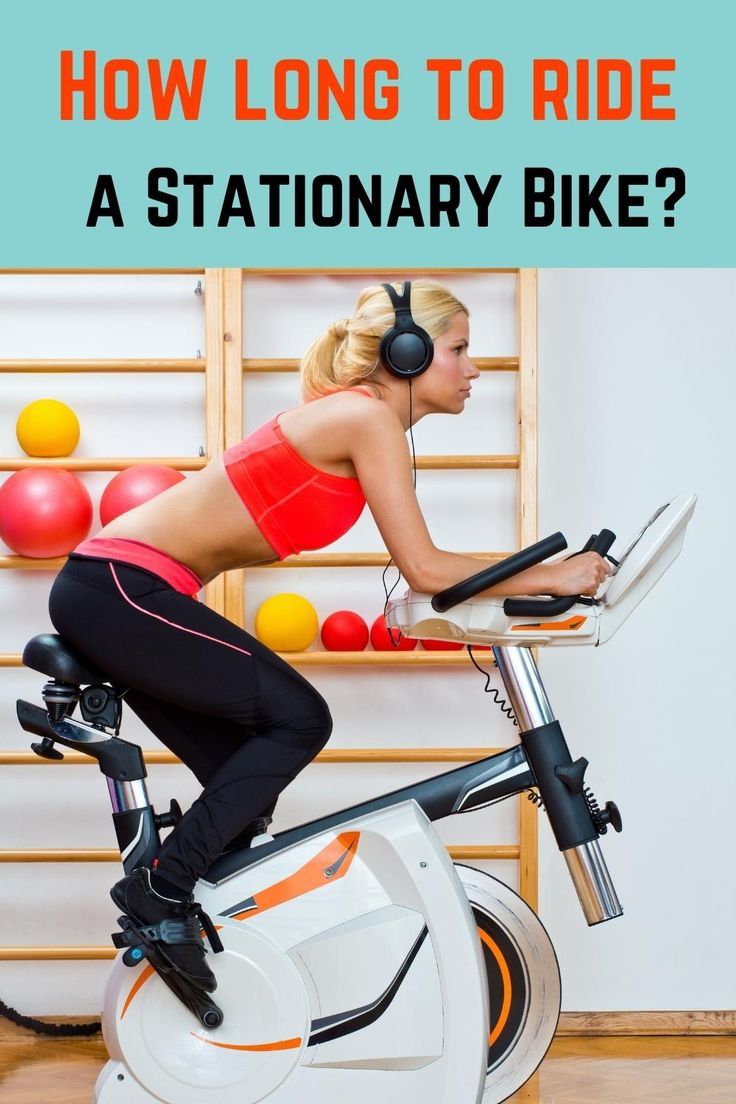 a woman on a stationary bike with headphones in her ears and text how long to ride a stationary bike?
