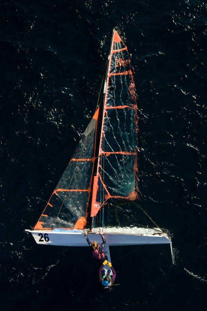 a person on a sailboat in the water with nets attached to it's sails