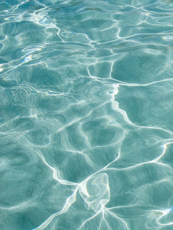 the water is crystal blue and has ripples on it's surface, as seen from above