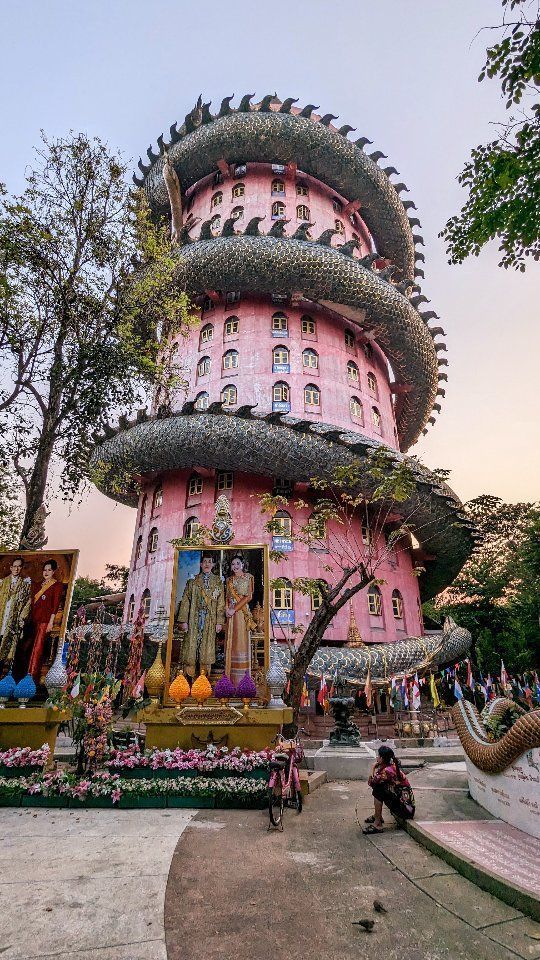a large pink building with lots of statues on it's sides