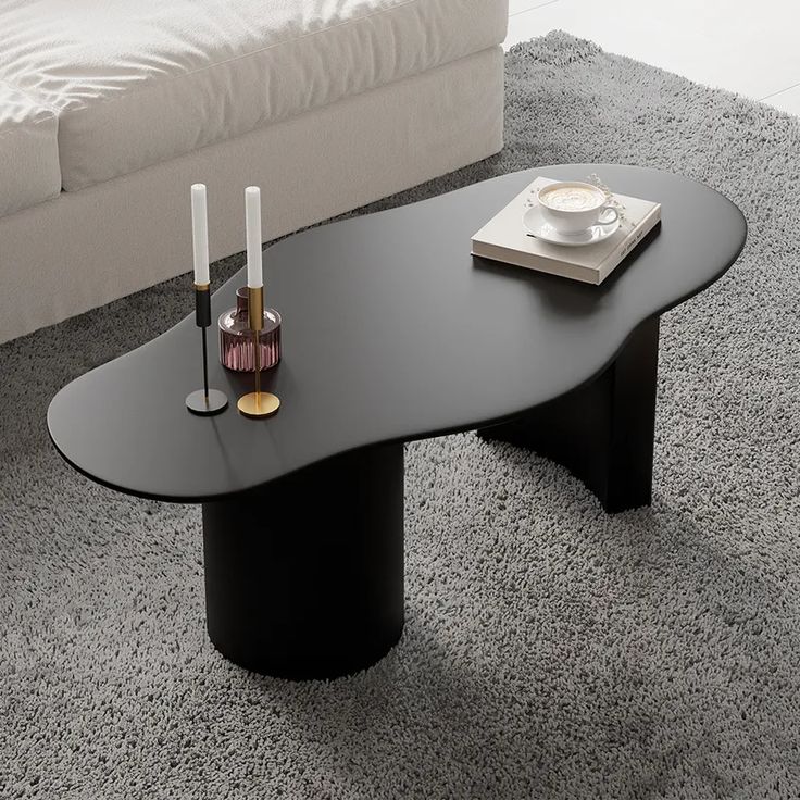 a coffee table with two candles on it