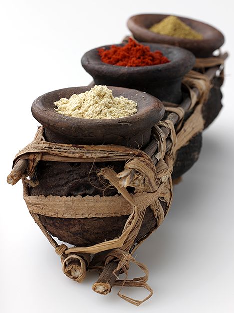 three wooden bowls filled with different types of spices on top of each other and tied together