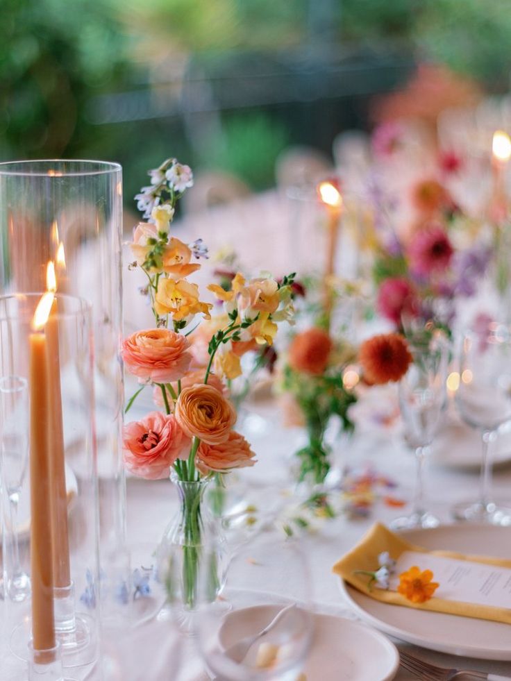 an image of a table setting with flowers and candles
