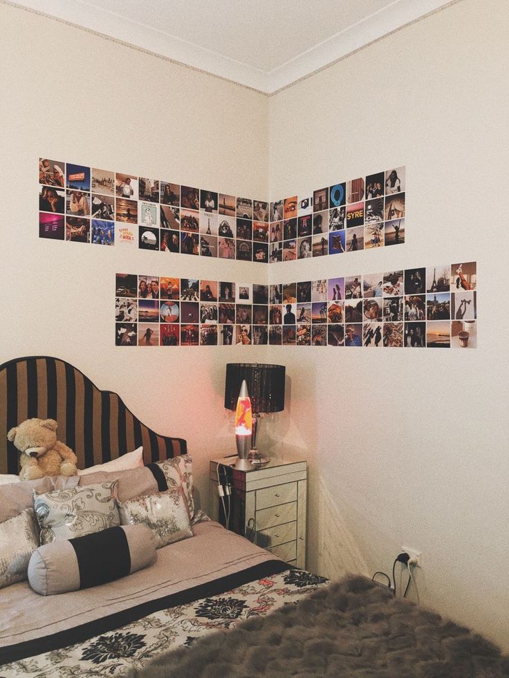 a bed room with a neatly made bed and lots of pictures on the wall