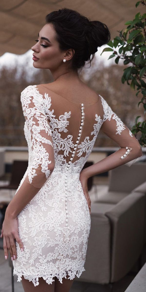the back of a woman's dress with white lace on it and open shoulders