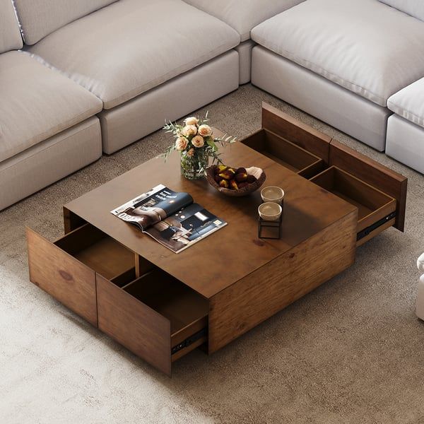 a living room with a couch, coffee table and magazine rack on the bottom shelf