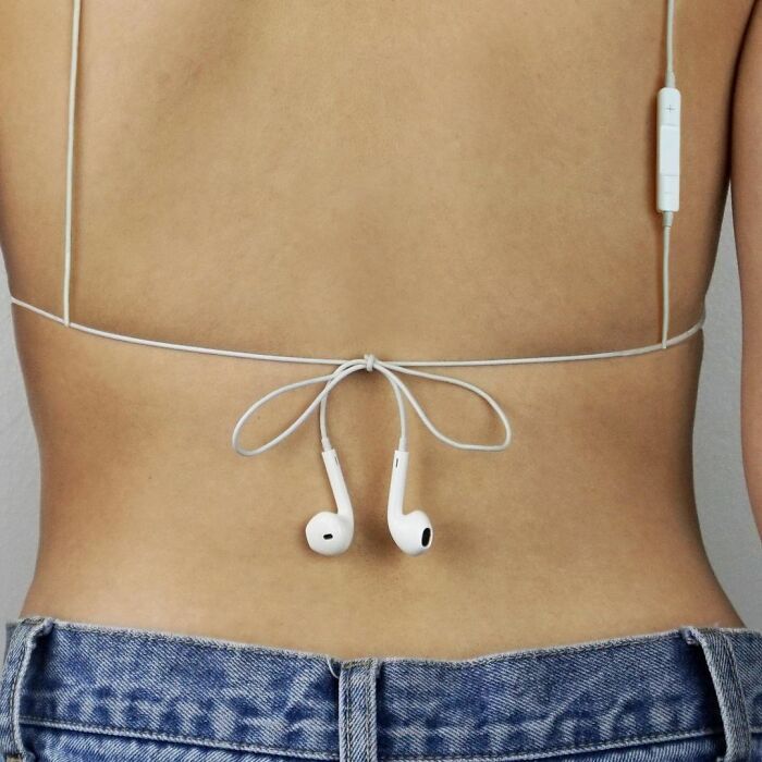 the back of a woman's stomach with headphones attached to her lower body