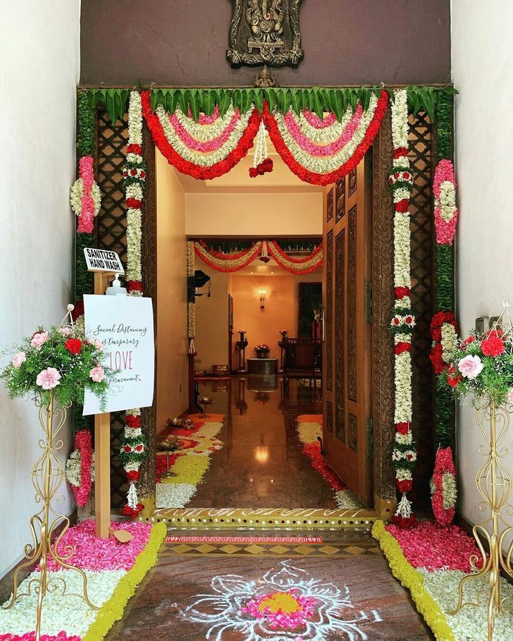 an entrance decorated with flowers and garlands