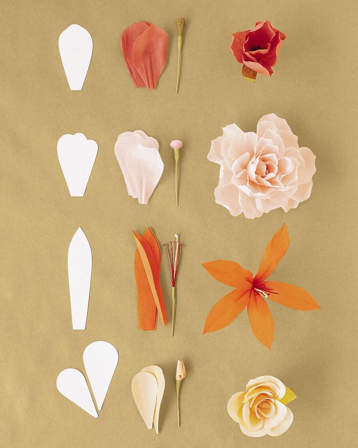 paper flowers are arranged on a brown surface