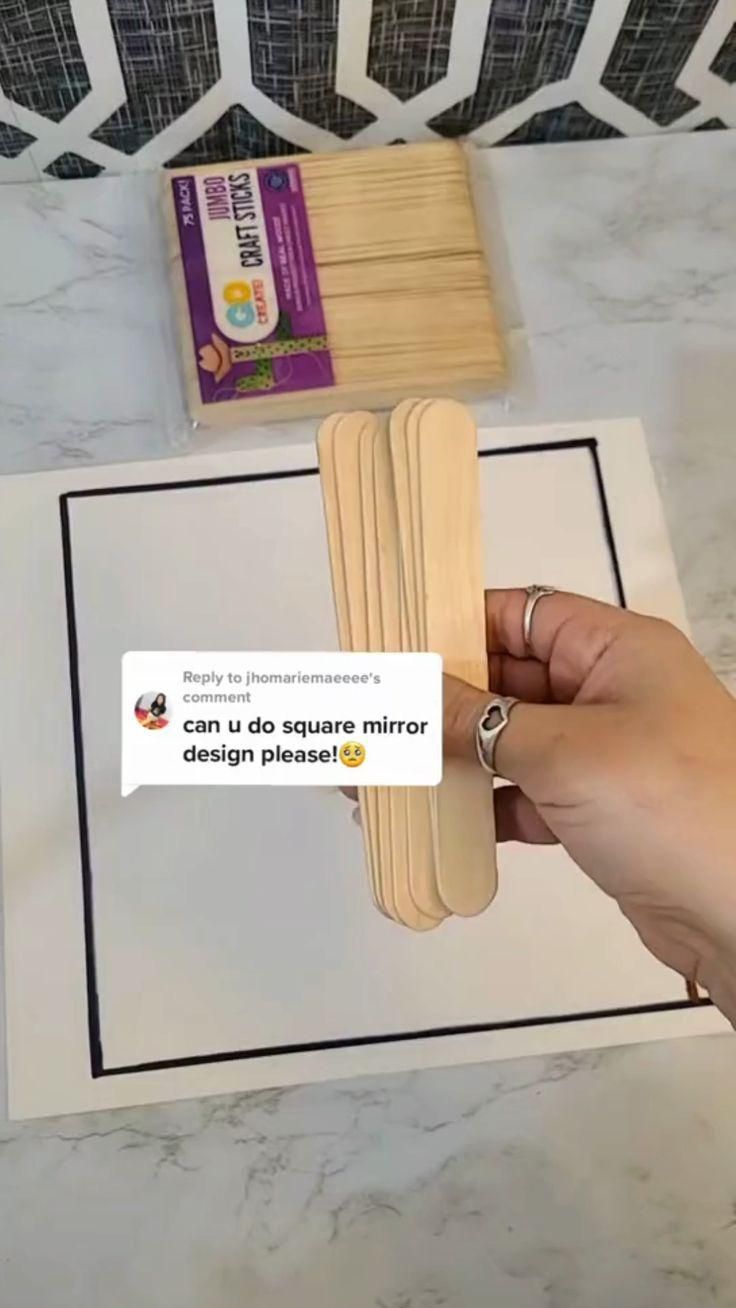 someone is holding a wooden matchstick in front of a tweet on the table