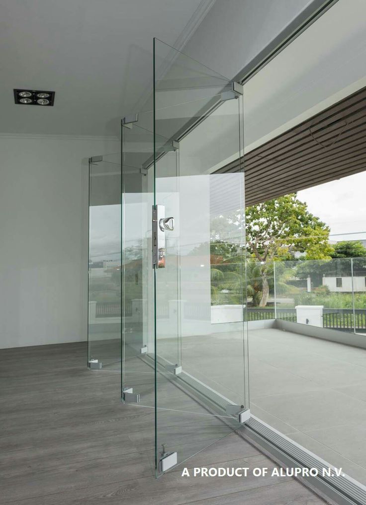 an empty room with glass walls and windows