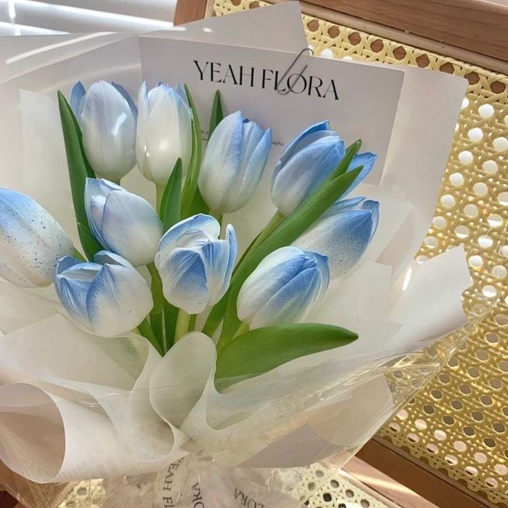 a bouquet of blue and white tulips on display