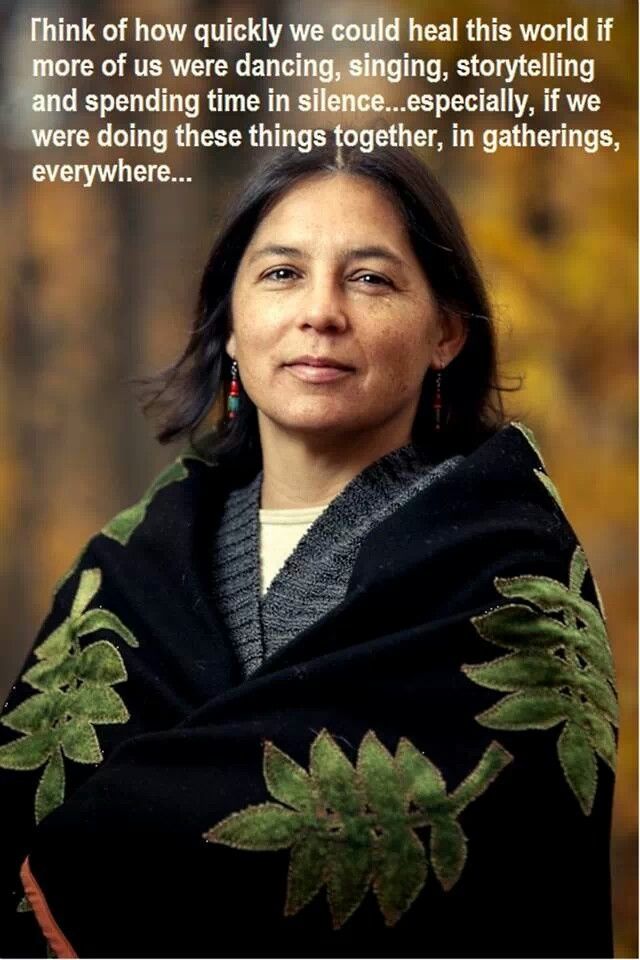 a woman wearing a black shawl with green leaves on it and a quote from the author