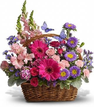 a basket filled with lots of colorful flowers