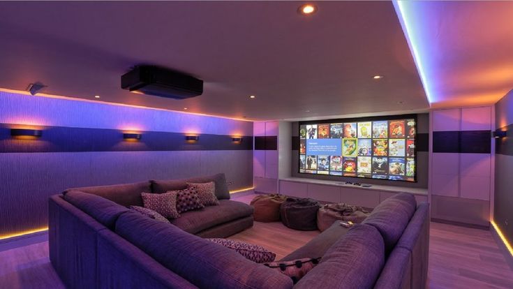 a purple couch sitting in front of a flat screen tv