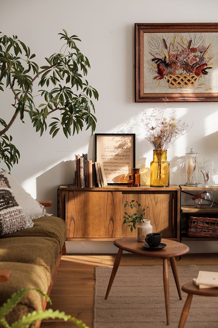 a living room filled with furniture next to a potted plant on top of a table