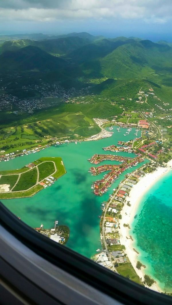 the view from an airplane looking out at a tropical island and lagoons in the ocean