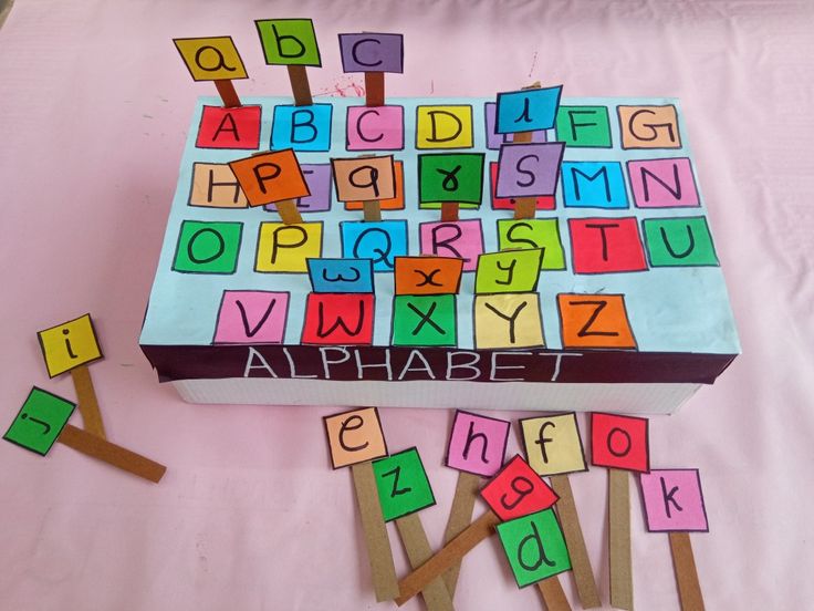 a box that has letters on it and some clothes pins sticking out of the top