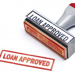 a rubber stamp with the words loan approved next to a red rubber stamp that says loan approved