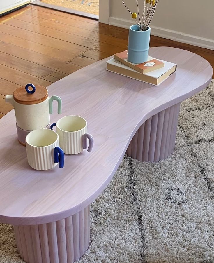 a coffee table with two mugs on it