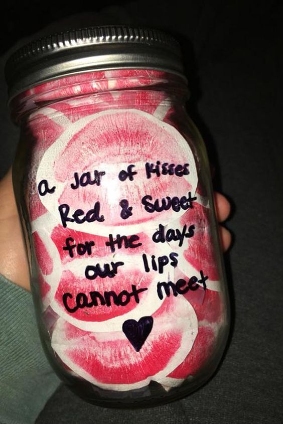 a person holding a jar with writing on it