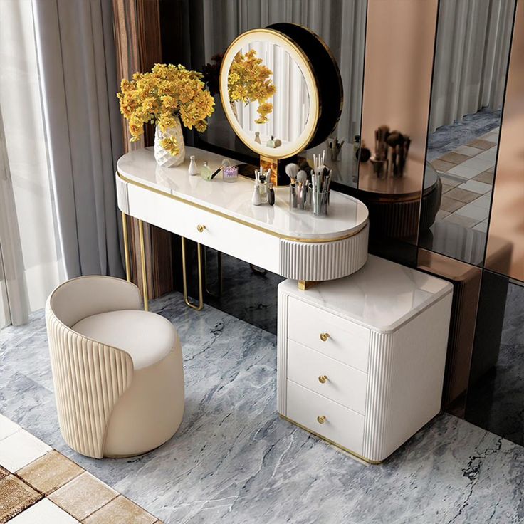 a dressing table with two stools and a round mirror on the wall next to it