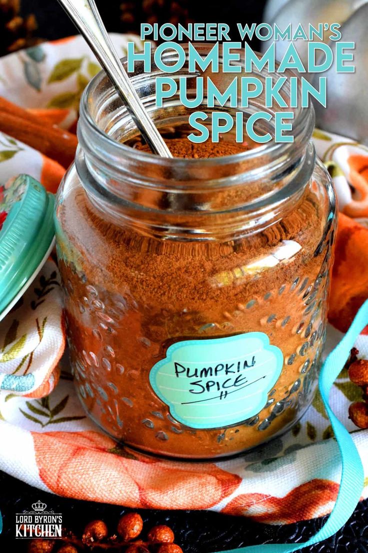 a jar filled with homemade pumpkin spice sitting on top of a table next to a spoon