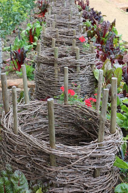 several baskets made out of branches in a garden
