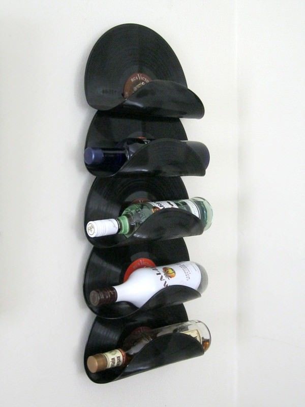 a wall mounted wine rack holding several bottles