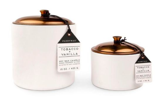 two white and gold canisters with labels on them