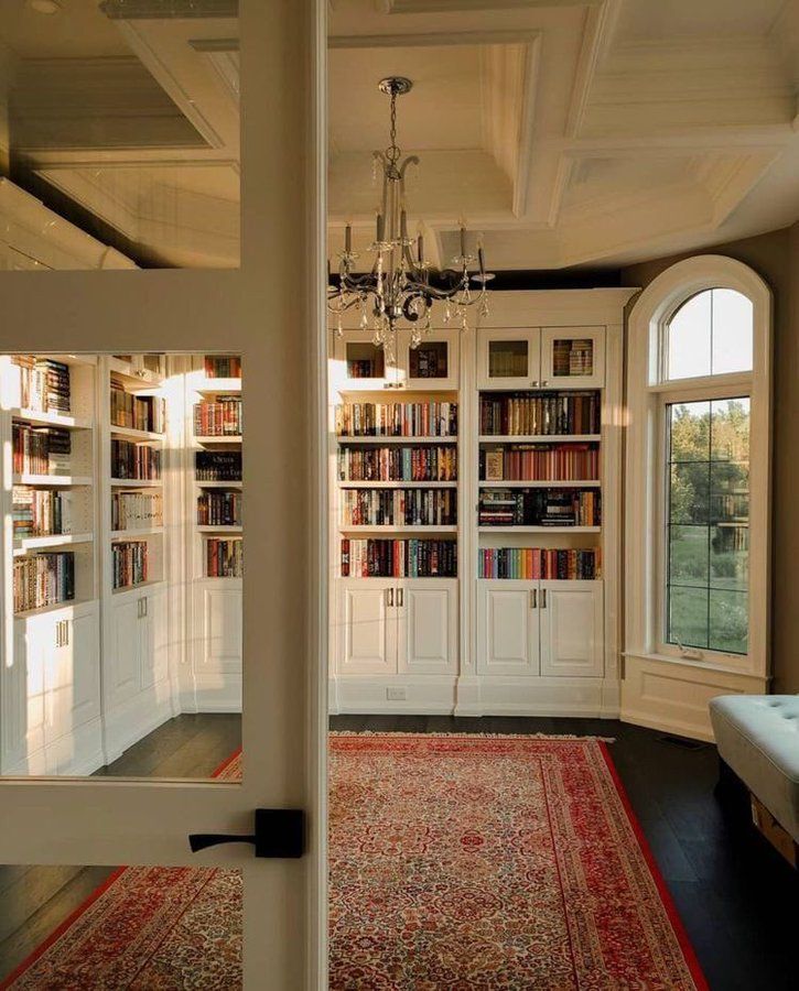 a room with many bookshelves and a chandelier