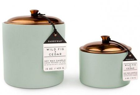 two teal jars with labels on them sitting side by side in front of each other