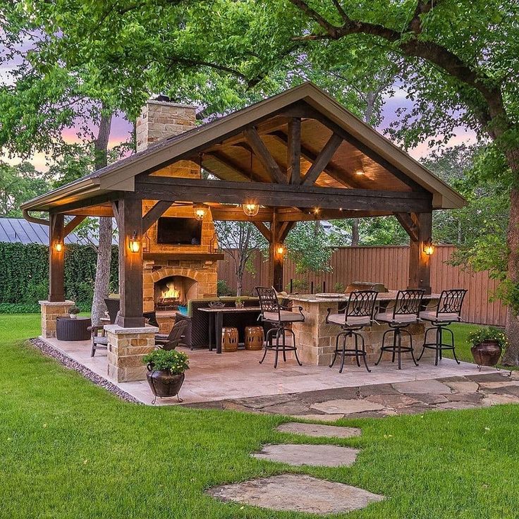 an outdoor kitchen and grill area in the backyard