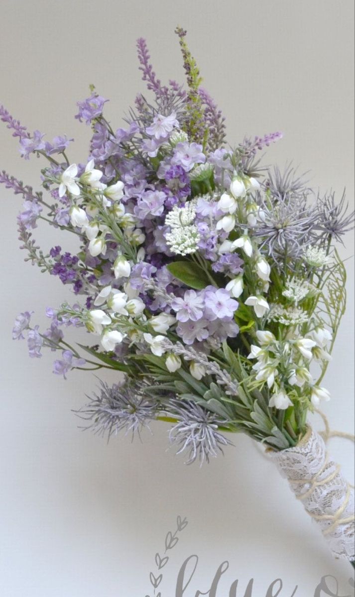 a bouquet of lavenders and white flowers with the word love written in cursive writing