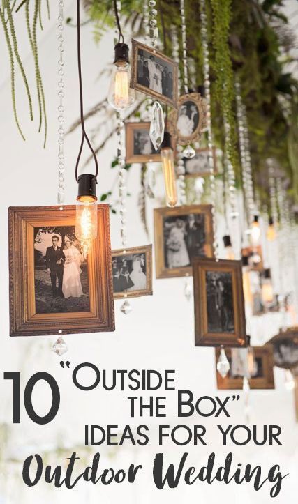 an outdoor wedding with pictures hanging from the ceiling