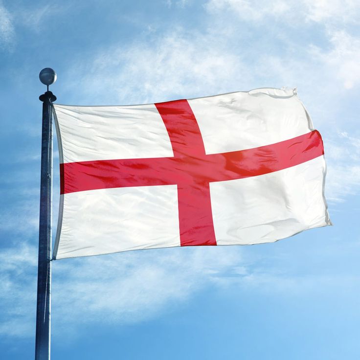 the flag of england is flying high in the sky