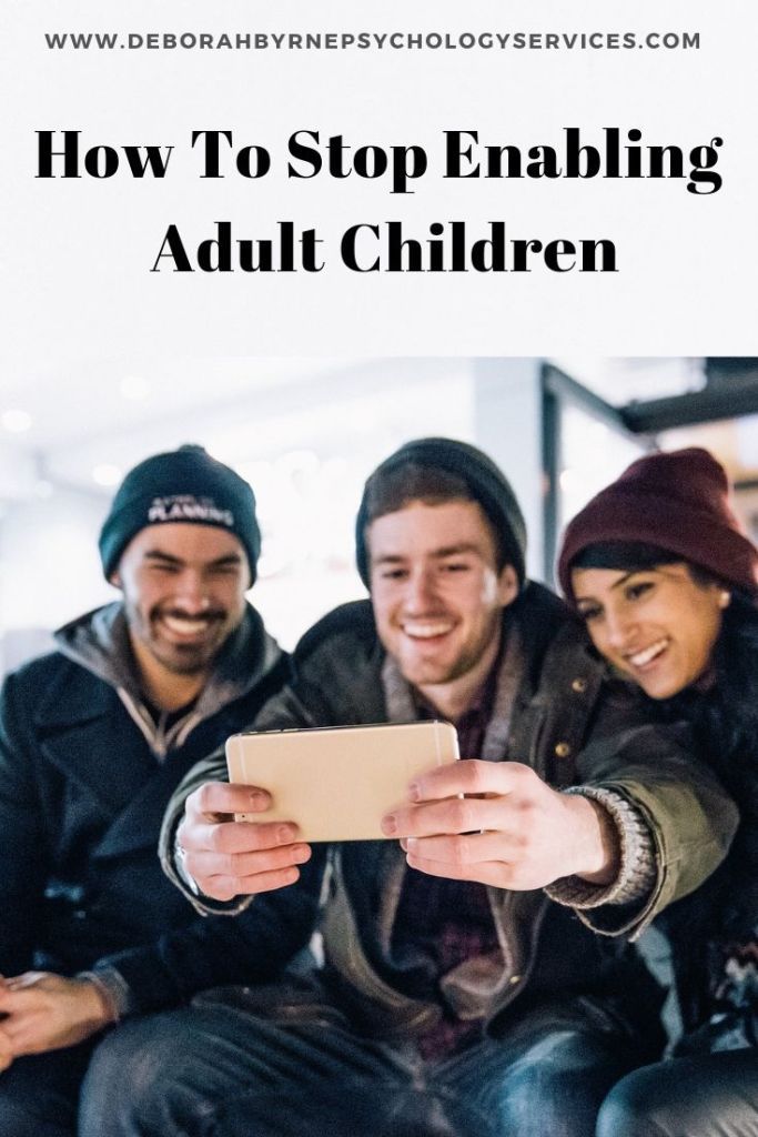 two men and a woman are smiling while looking at an electronic device with the text how to stop embabing adult children