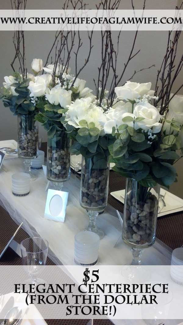 a table with vases filled with white flowers on top of it and the words elegant centerpiece from the dollar store below