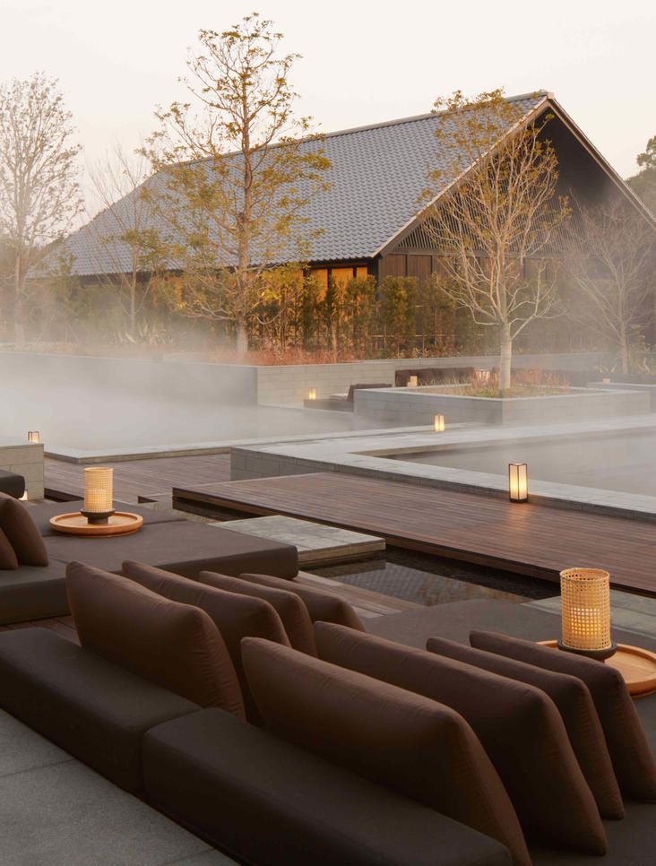 an outdoor lounge area with steam rising from the ground